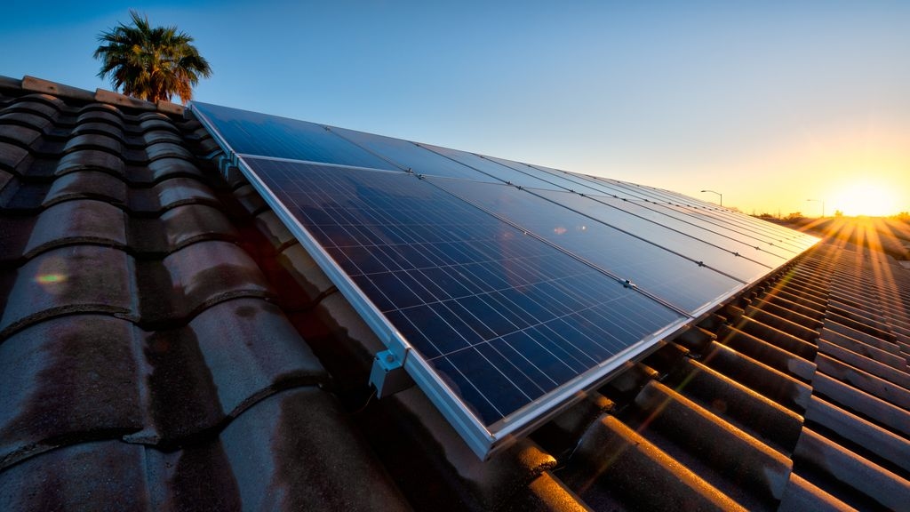 Image of solar panels on a roof taken from a close and low angle.