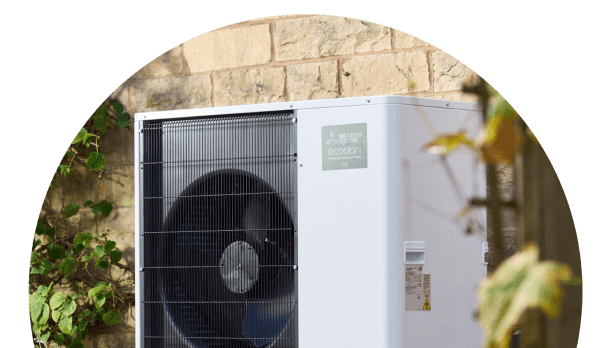 a circle image of an air source heat pump outside a building